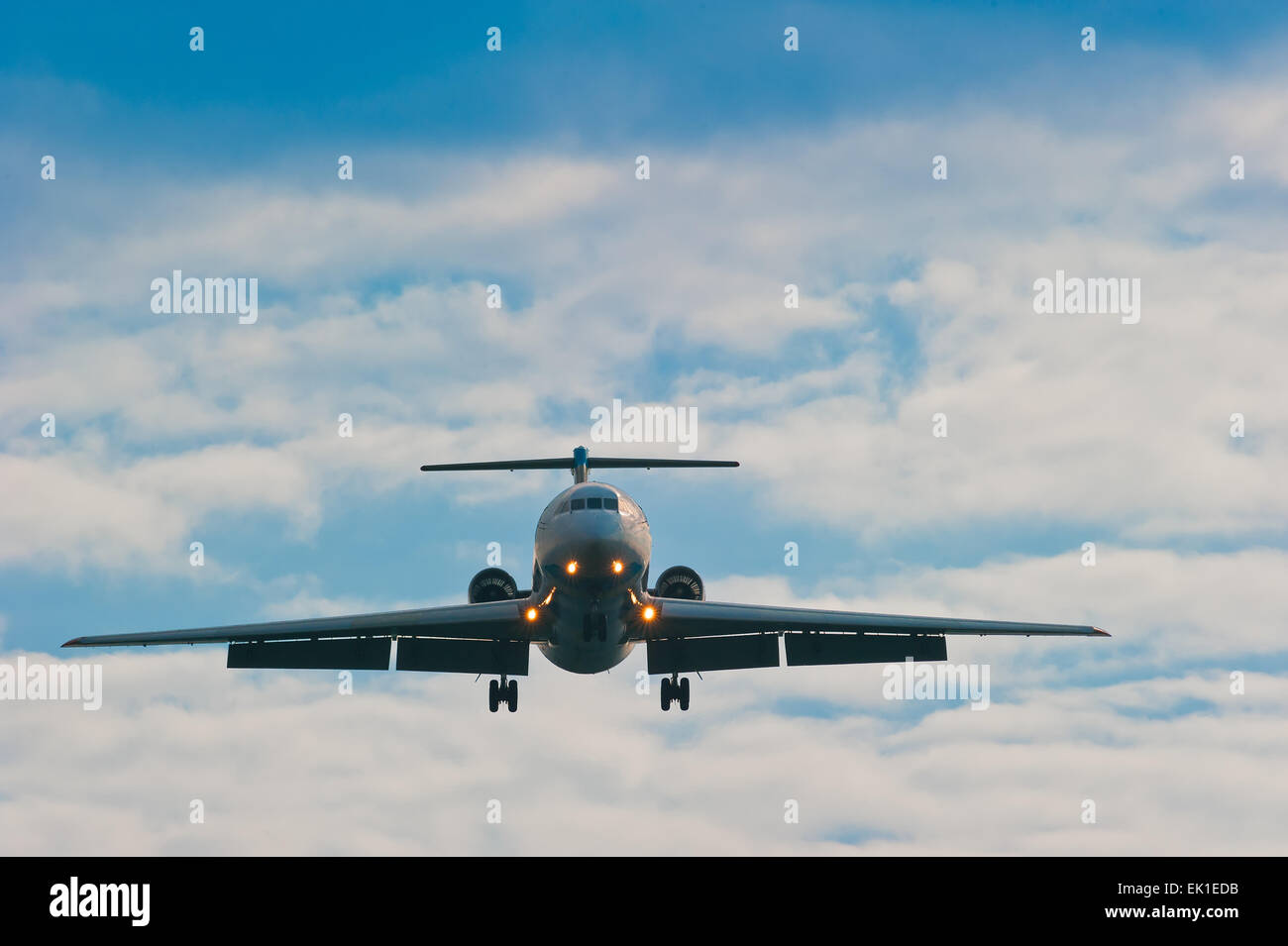 plane on sky background with gear and flaps ready for planting Stock Photo