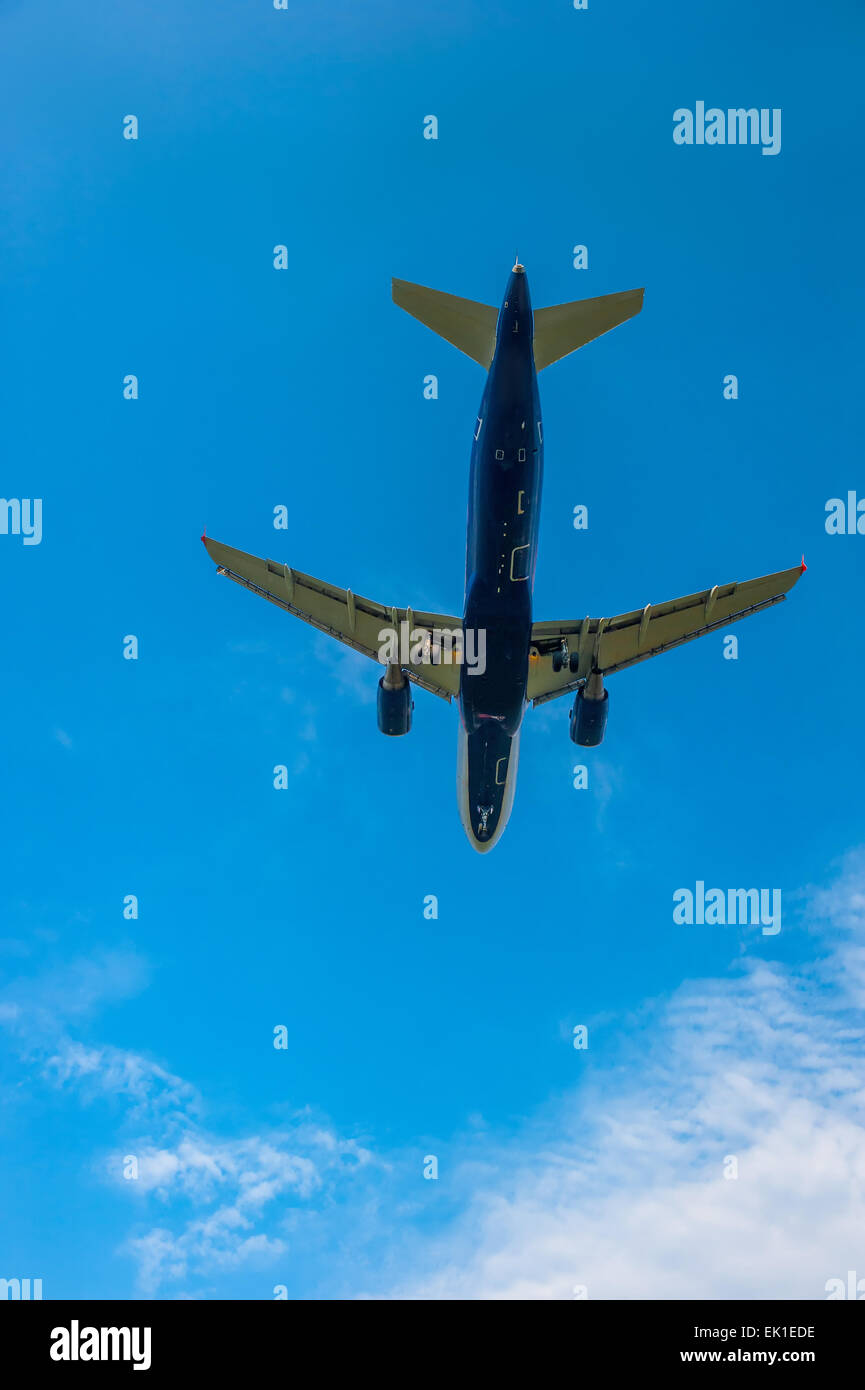 Vertical picture of a flying airplane in the sky Stock Photo