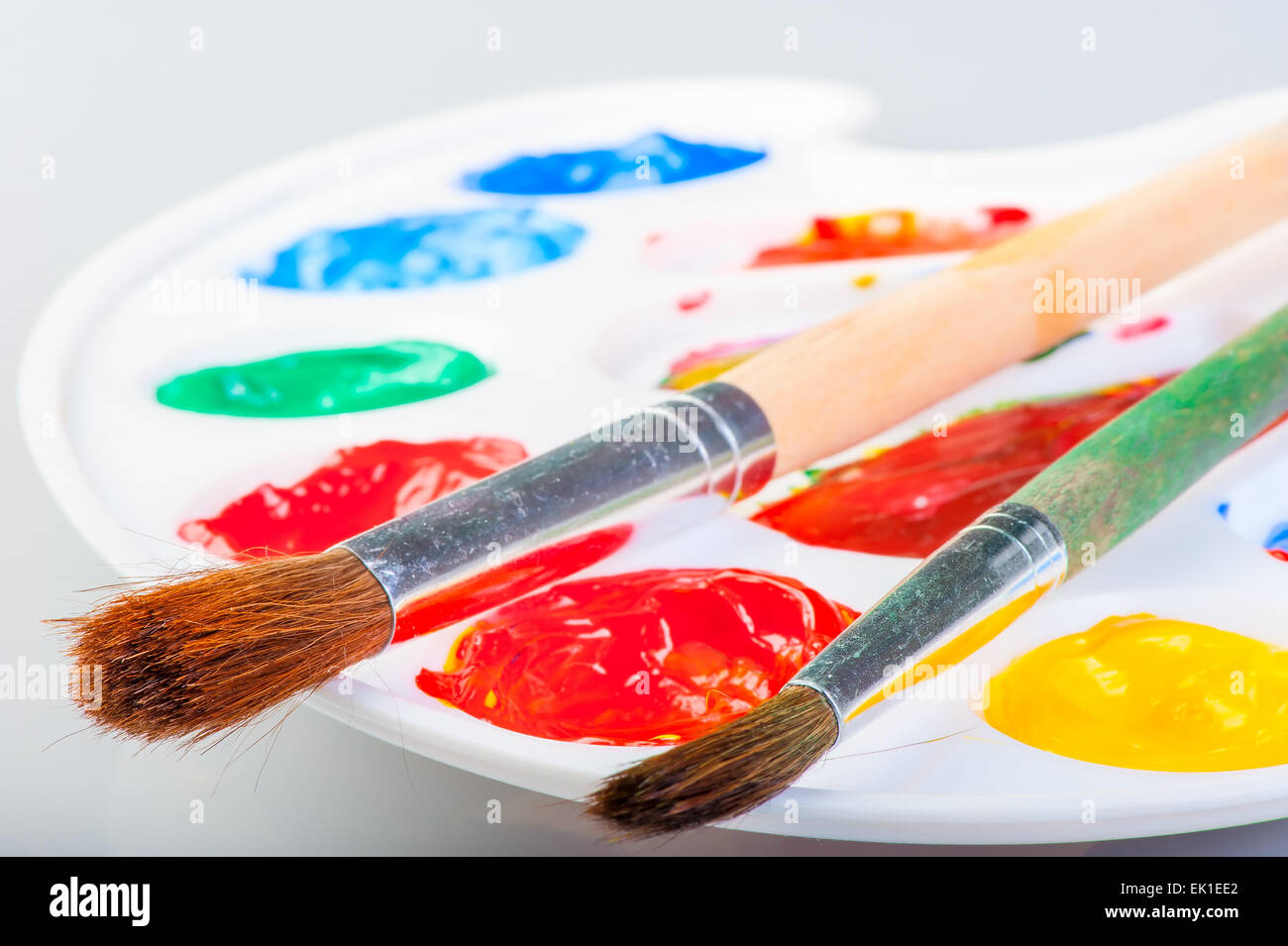 palette with paints and two brushes Stock Photo - Alamy