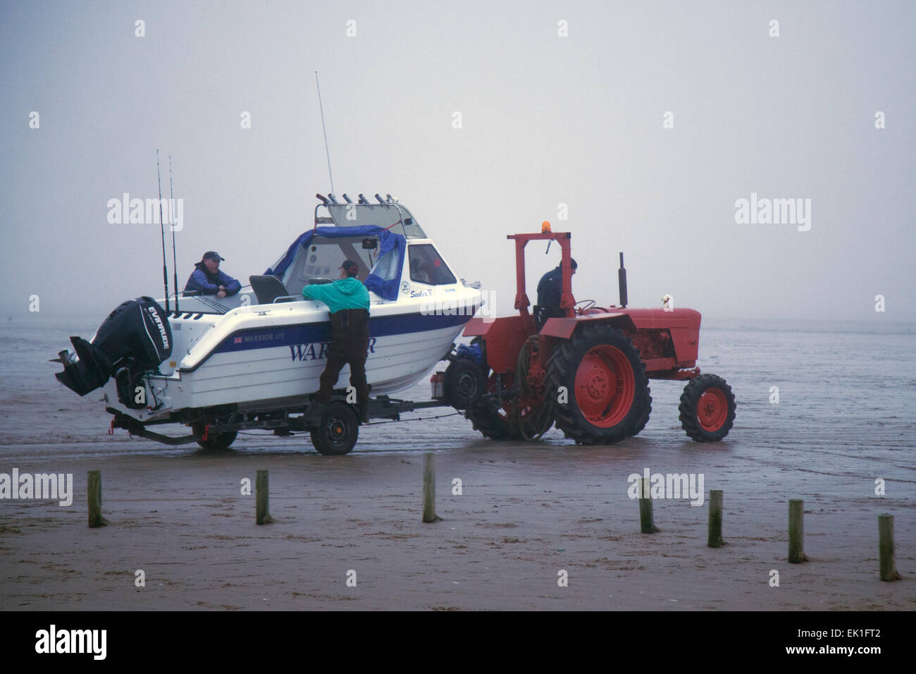 Ainsdale, Southport, Sefton, Merseyside, UK. 5th April, 2015. UK Weather:  Foggy, Misty and Damp on the West Coast as rod and line Sea Fisherman take advantage of the calm conditions to launch their boats, with a David Brown tractor,  and fish the incoming tide.  Credit:  Mar Photographics/Alamy Live News Stock Photo