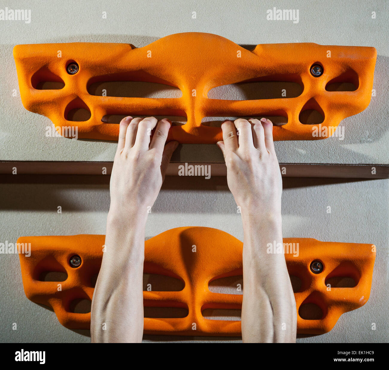 Cropped view of rock climber performing pullups on fingerboard Stock