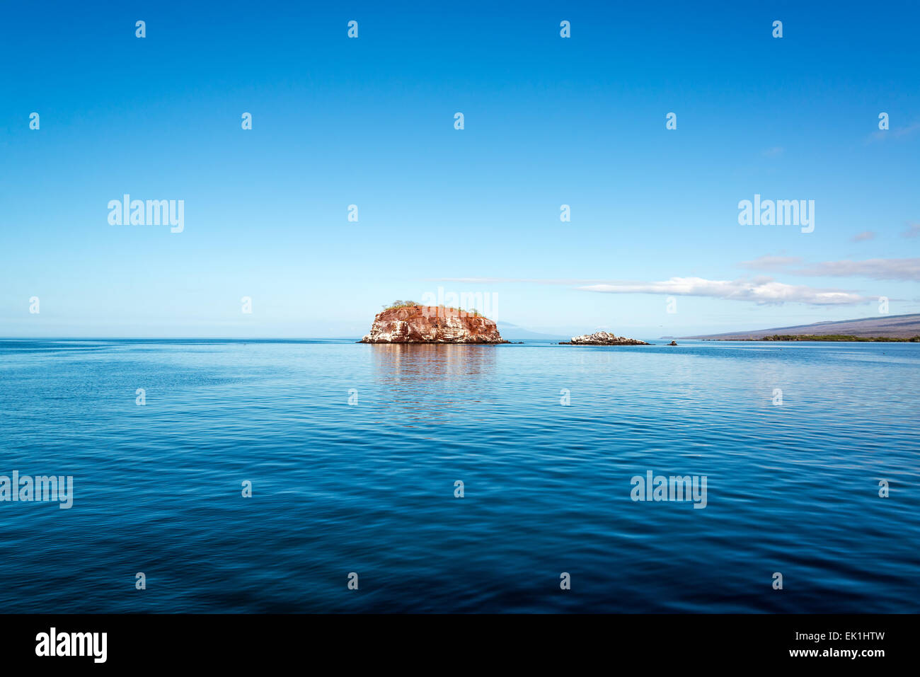 Small island and deep blue water off the coast of Isabela in the Galapagos Islands Stock Photo