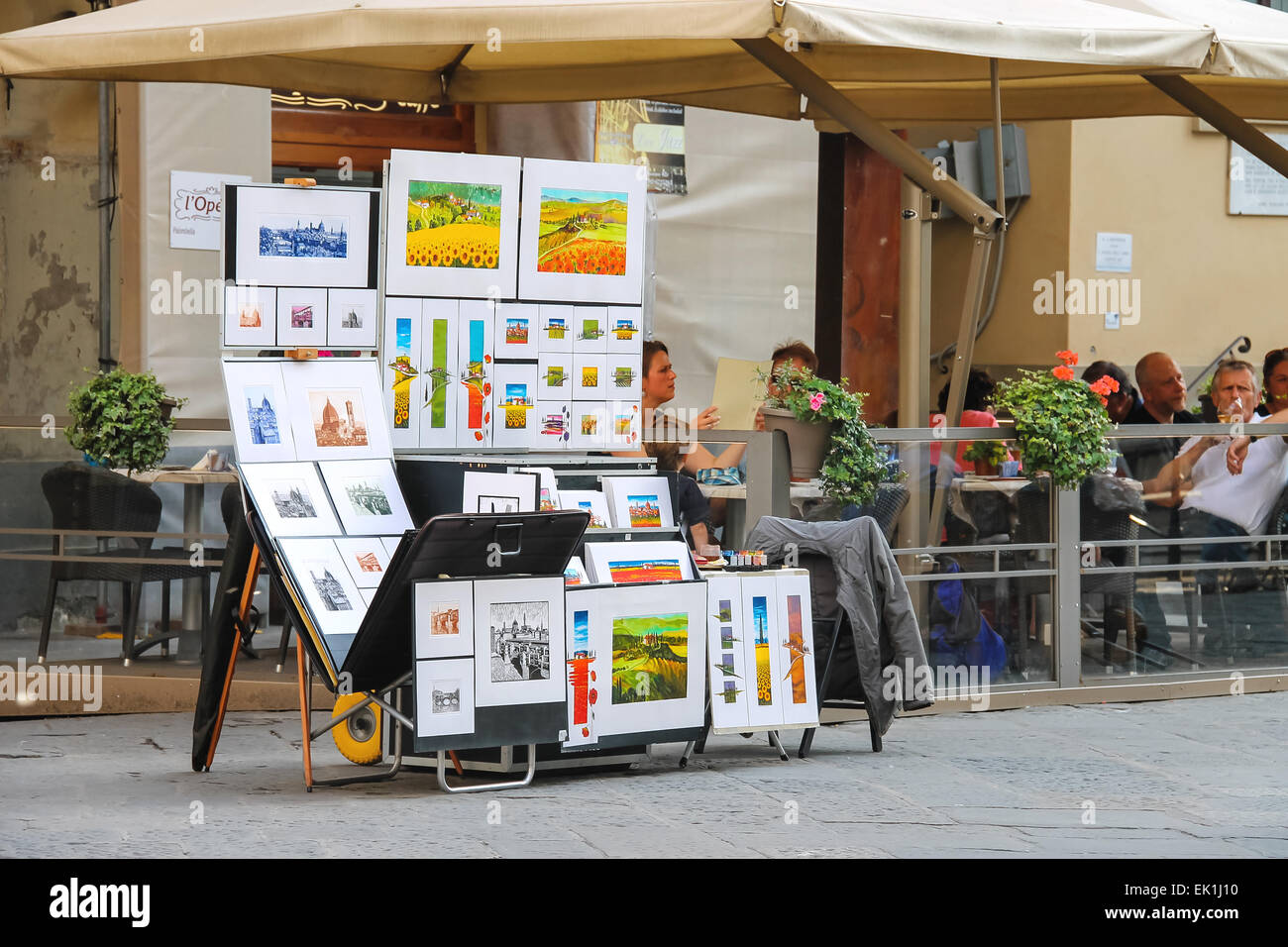 FLORENCE, ITALY - MAY 08, 2014: Equipment and drawings street artist outside restaurant in Florence, Italy Stock Photo