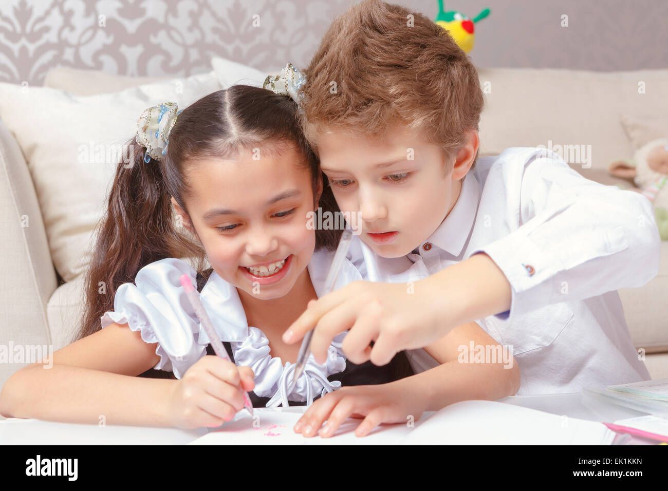 Boy and girl do tasks together Stock Photo Alamy