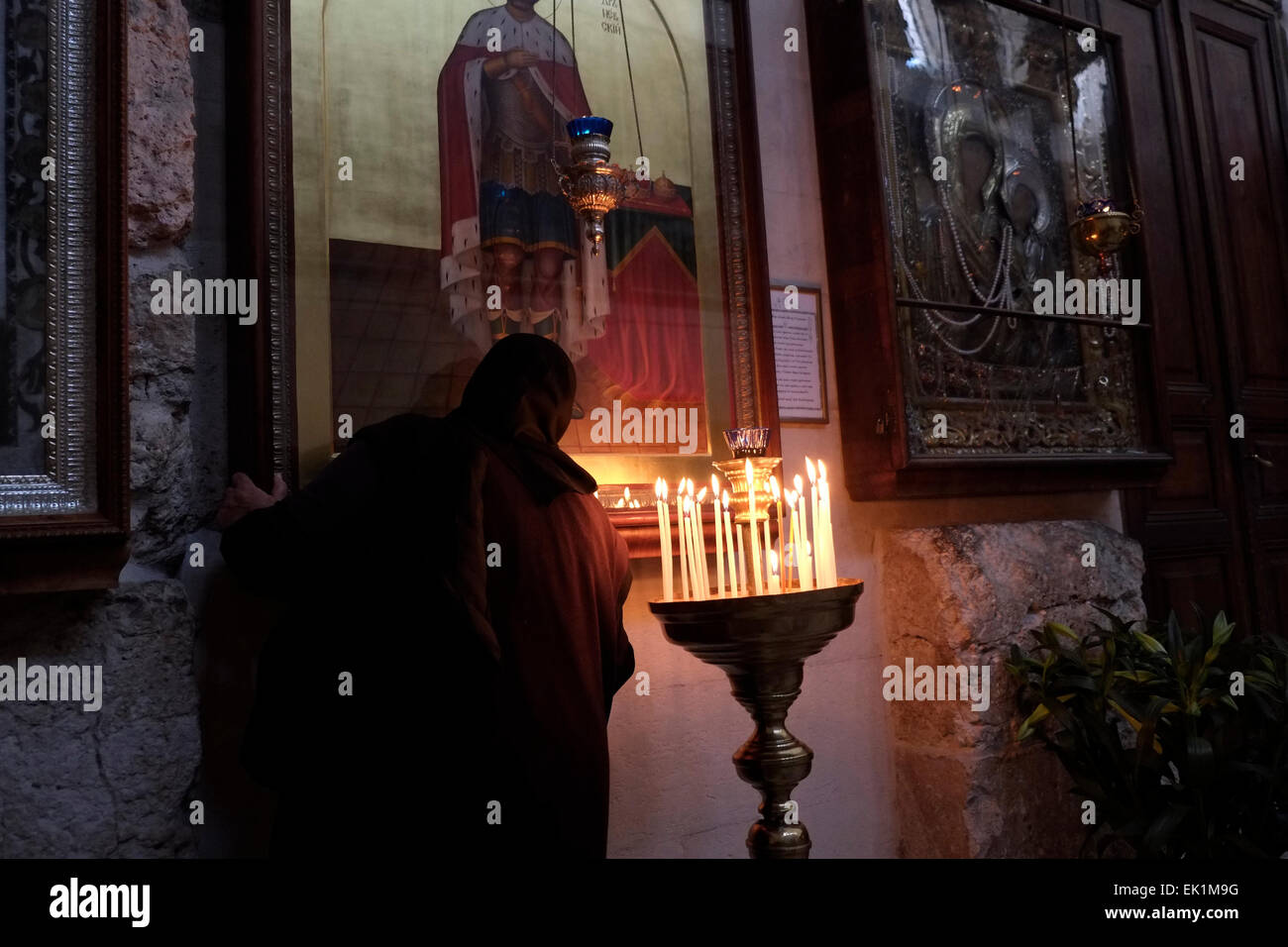 An Eastern Orthodox devotee visiting the Russian Church of Saint Alexander Nevsky in the Christian quarter old city East Jerusalem Israel Stock Photo