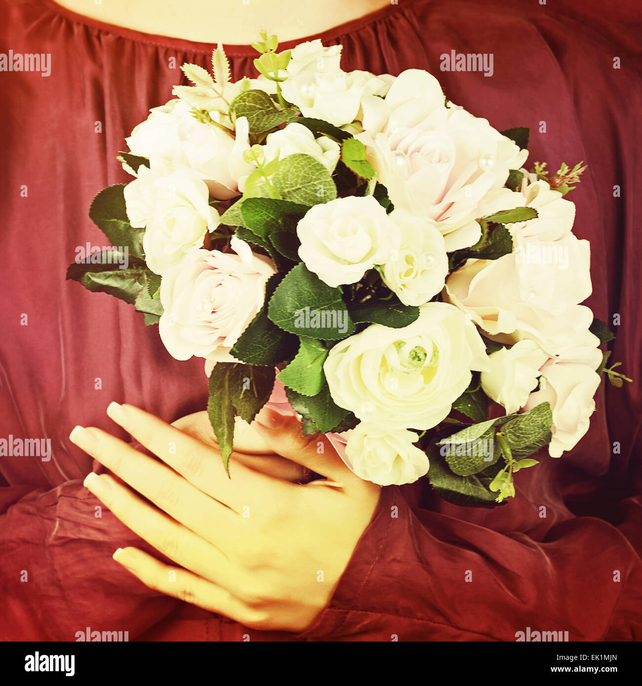 Beautiful wedding bouquet from white and pink roses in hands of bride ...