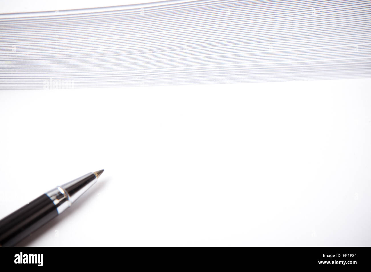 white paper with free space for sample text, envelopes in background, pen beside Stock Photo