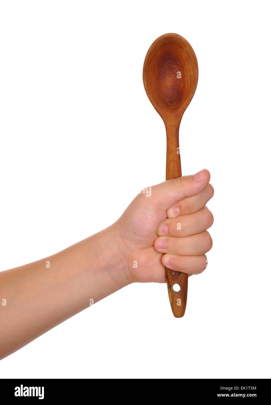 Wooden spoon in baby hand over white background Stock Photo
