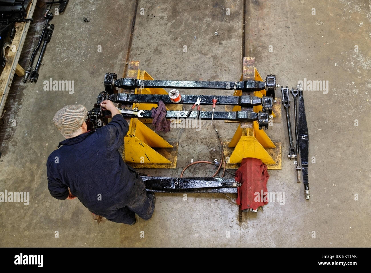 An engineer working to restore & repair the suspension parts of a tram