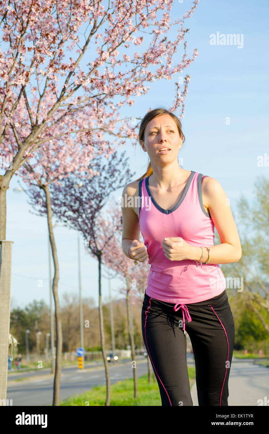 Young girl jogging on a sunny day Stock Photo