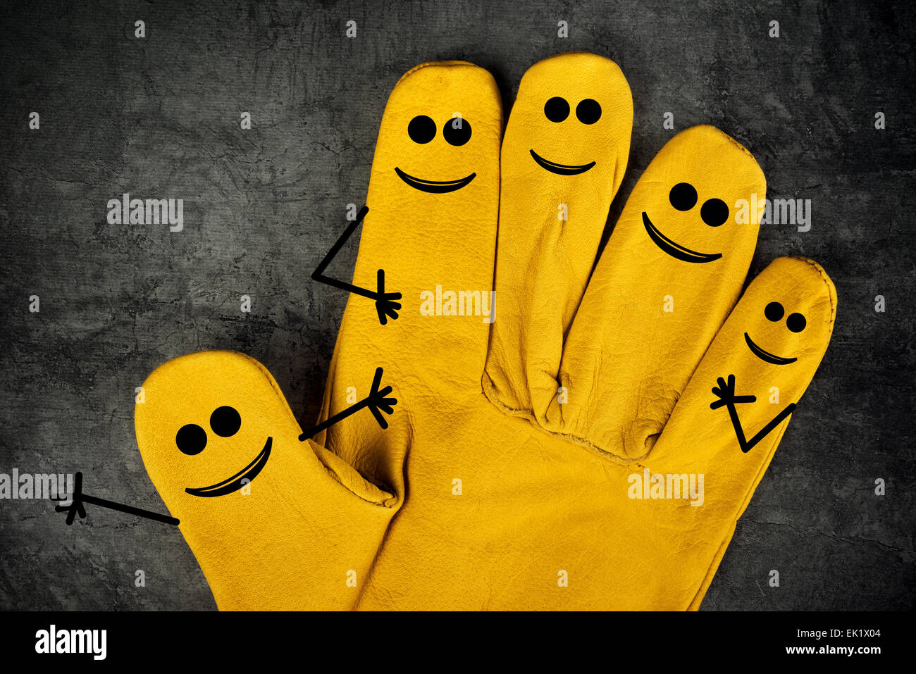 Five Happy Laughing Smileys on Fingers of Yellow Leather Protective Construction Industry Working Gloves Stock Photo
