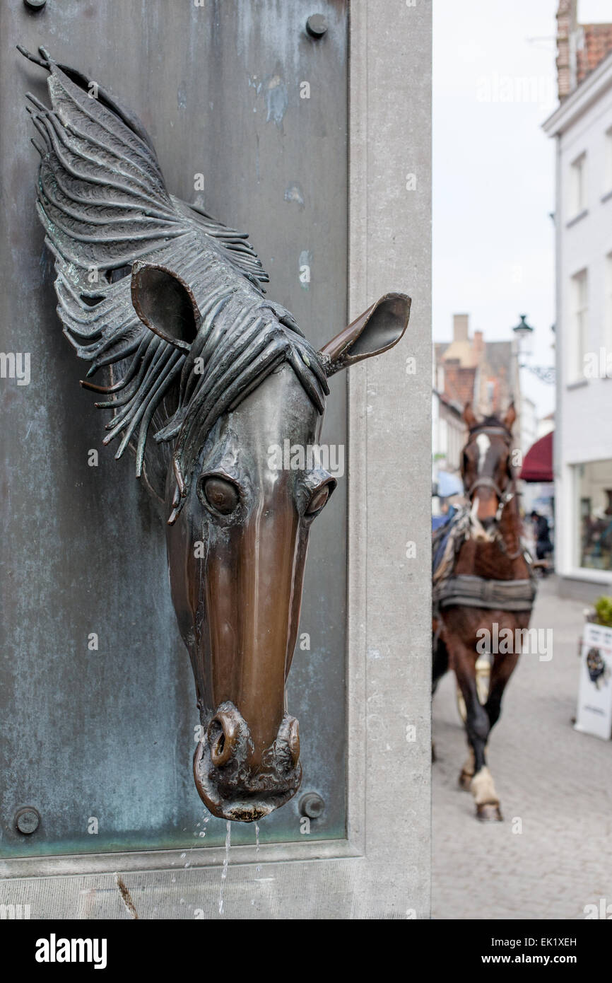 Horse Statue and tourist horse and cart, Bruges, Belgium Stock Photo