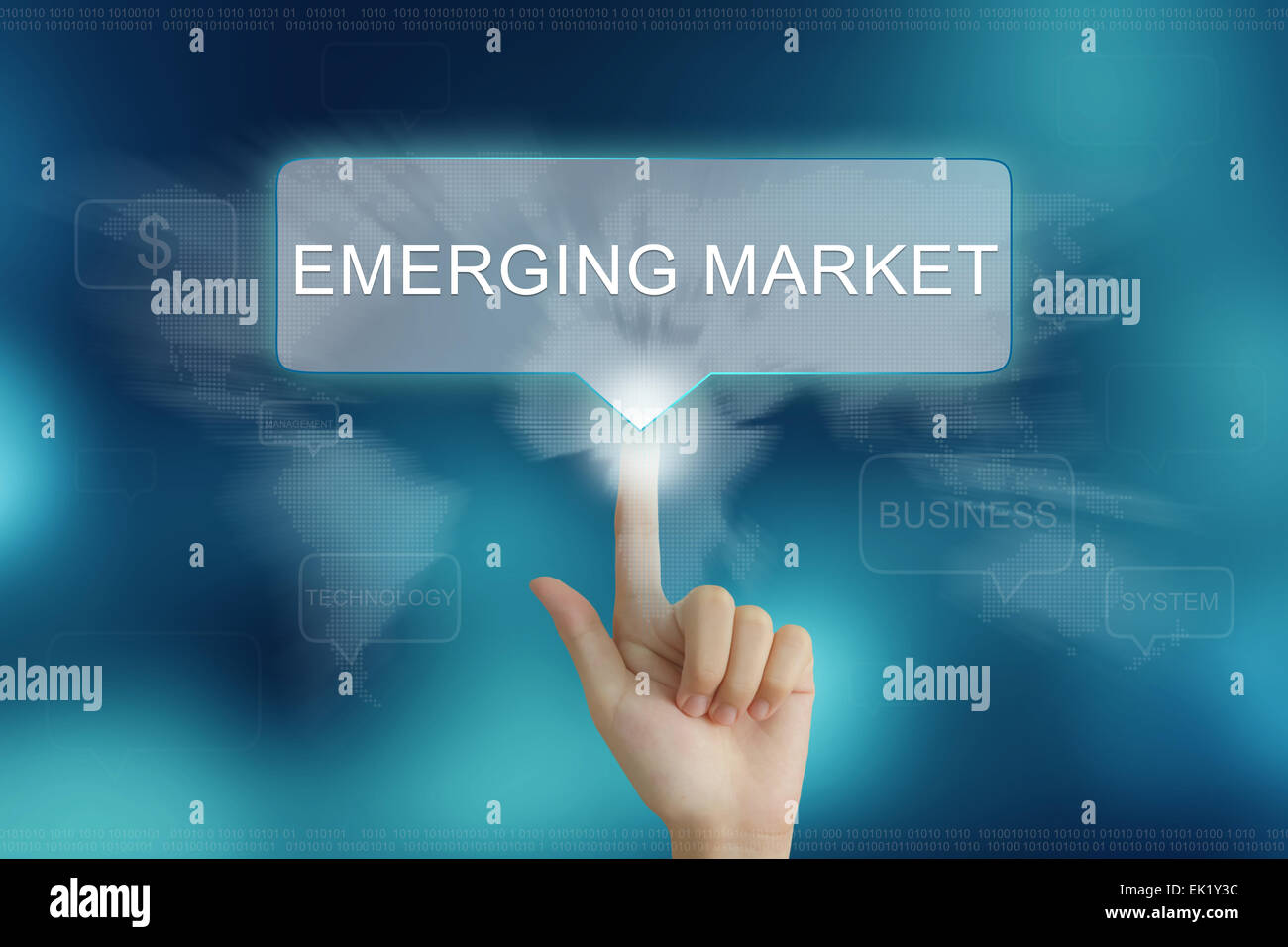 hand pushing on emerging market balloon text button Stock Photo