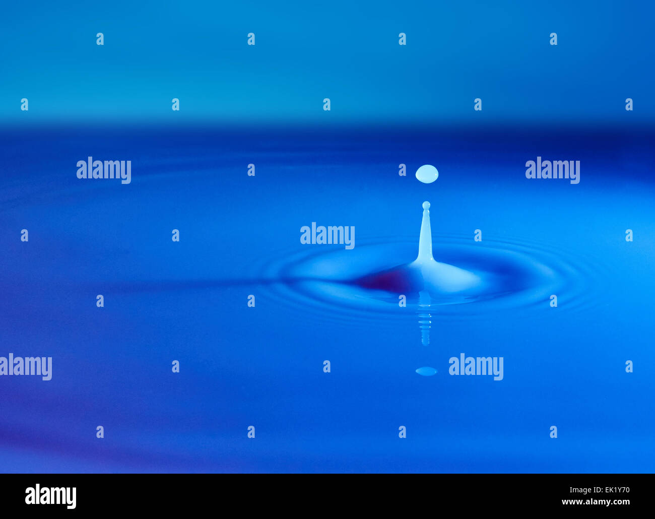 Drop of water on surface of milky white liquid Stock Photo Alamy