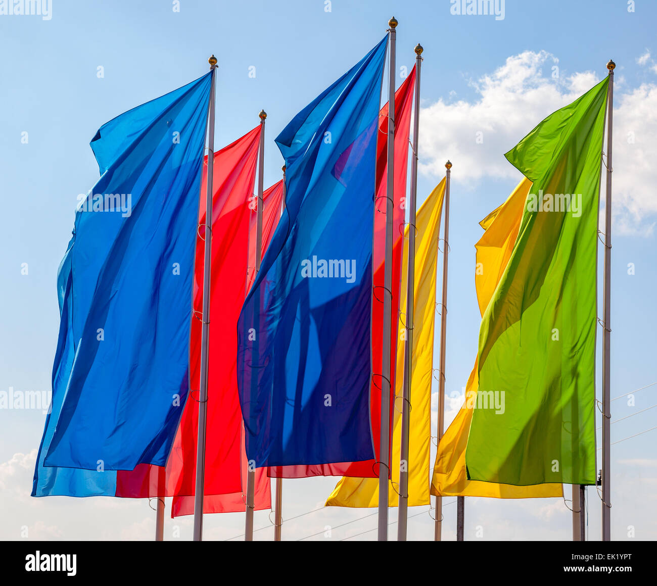 Colorful flags waving on blue sky background Stock Photo - Alamy