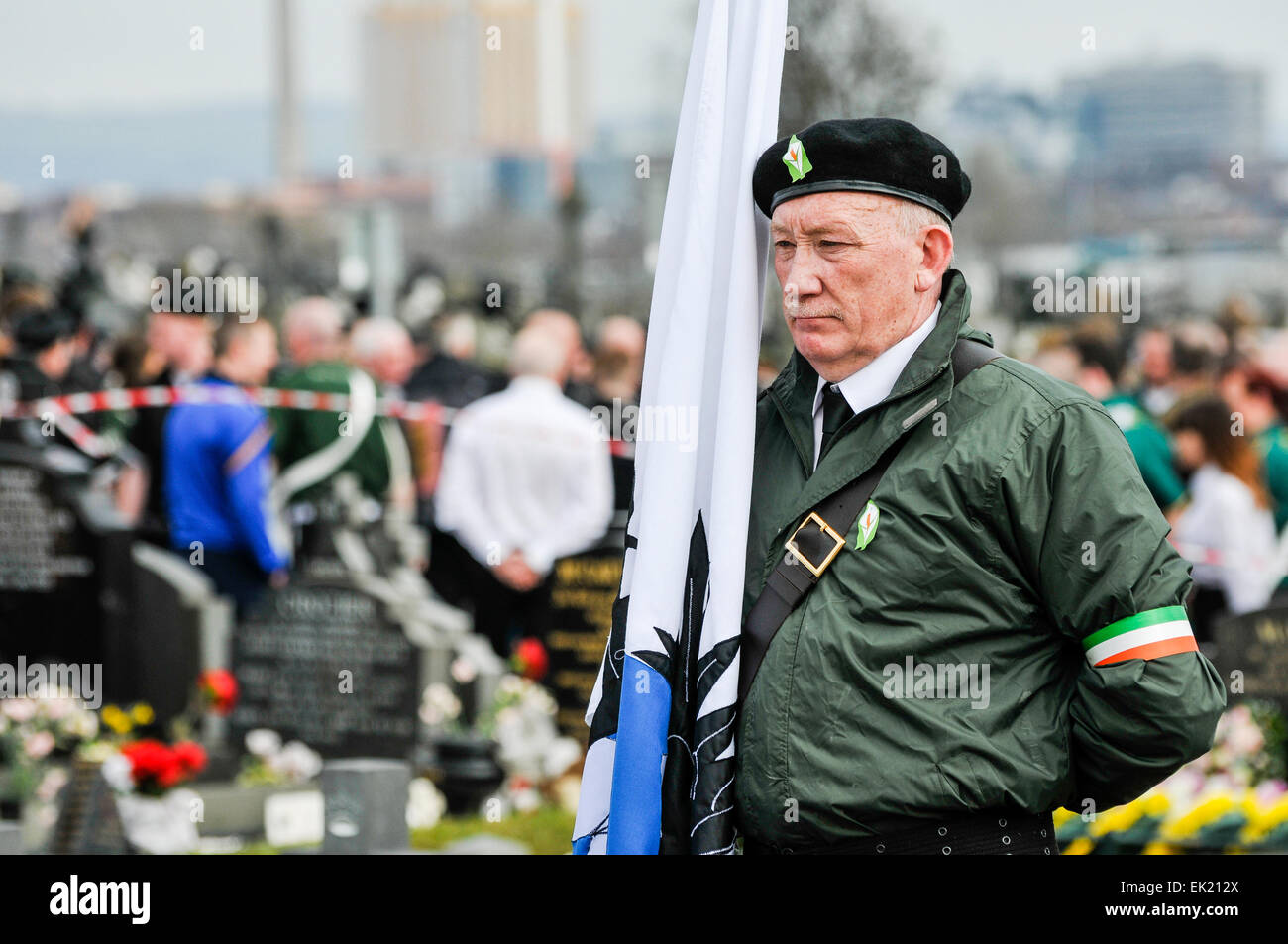 Belfast, Northern Ireland, UK. 5th April, 2015. A man dressed in a paramilitary style uniform holds a flag as the National Graves Association and Sinn Fein commemorate the 99th anniversary of the Irish Easter Rising, Belfast Credit:  Stephen Barnes/Alamy Live News Stock Photo