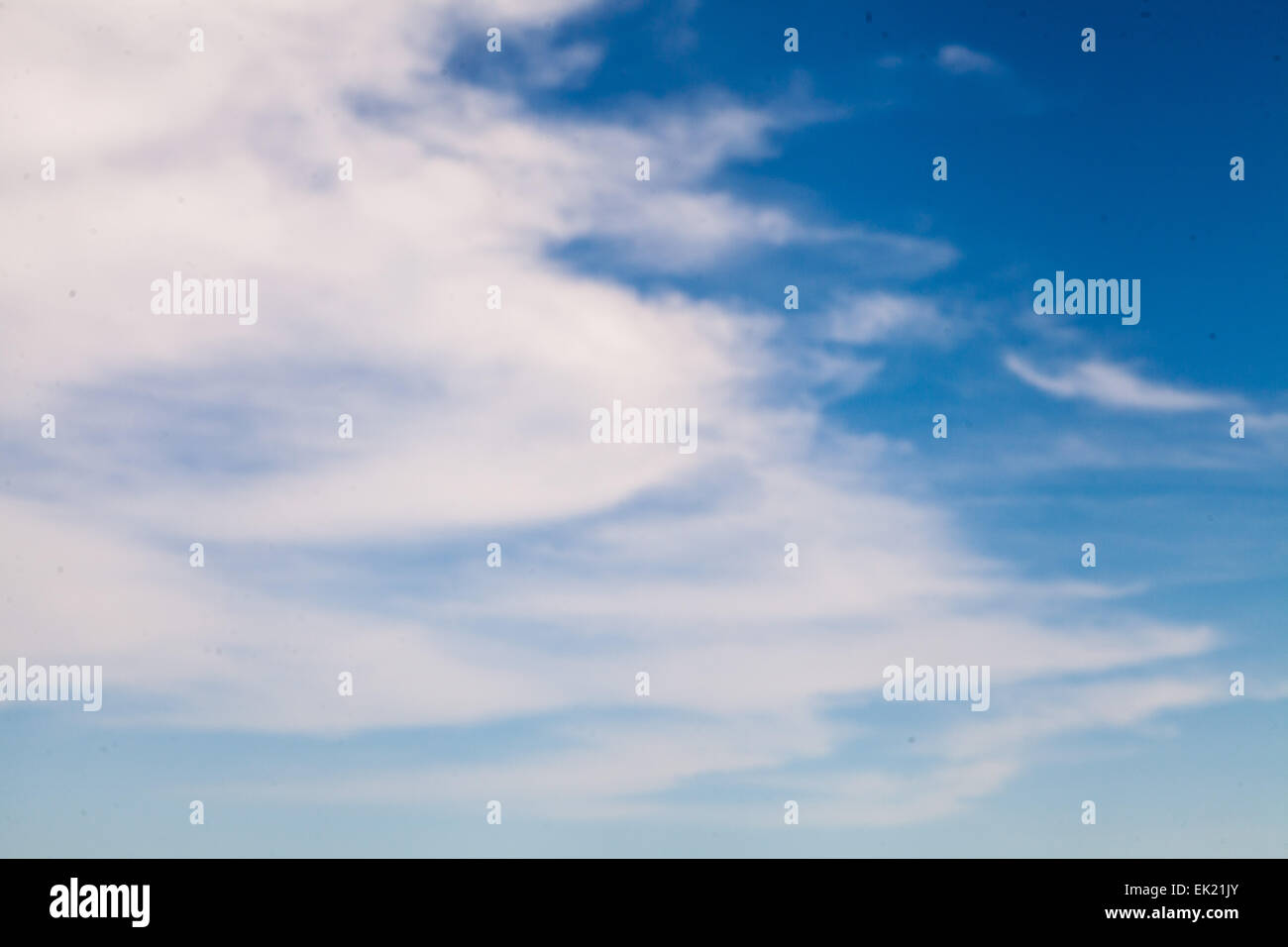 white streaky clouds in a dark blue sky. it is easy to daydream and drift off with clouds like this. Stock Photo