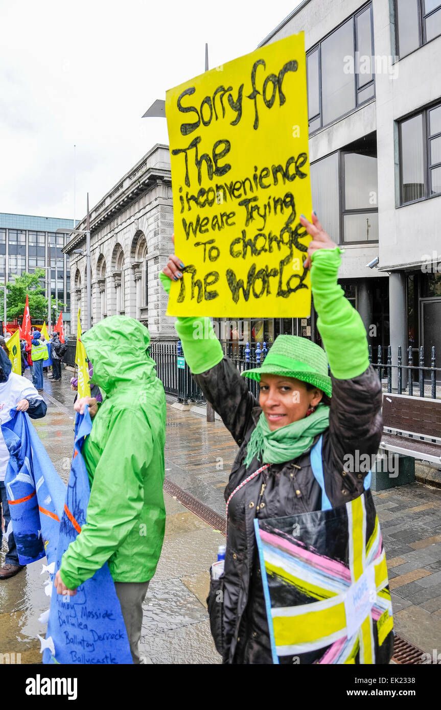 Belfast, Northern Ireland. 15th June 2013. A woman holds up a banner which says "Sorry for the inconvenience. We are trying to change the World" at an anti-G8 protest organised by the Irish Congress of Trade Unions (ICTU) Stock Photo