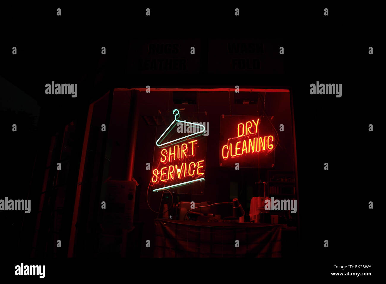 Night view shop window red neon signs, 'Shirt Service', 'Dry Cleaning