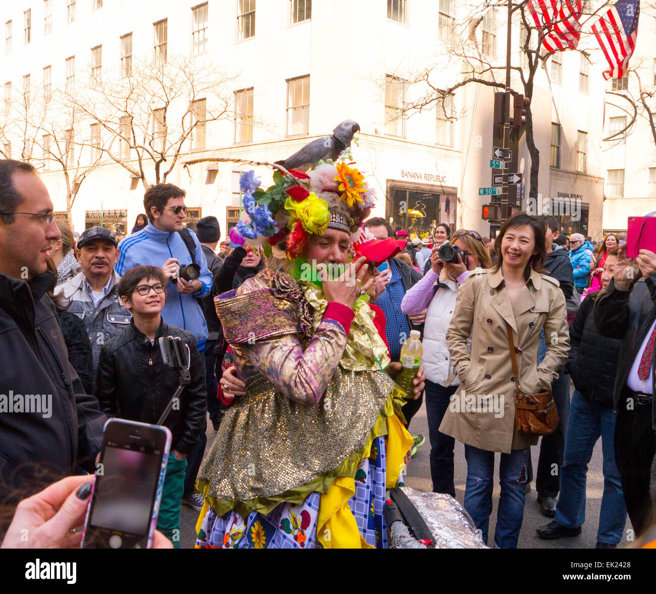 New York, USA. 5th April, 2015. A man dressed up with a Gray Parrot on his head  during The 2015 Easter Parade and Easter Bonnet Festival in New York City Credit:  Donald bowers/Alamy Live News Stock Photo