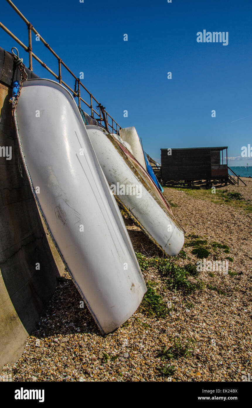 Rowing boats against the sea wall at Southend on Sea, Essex, UK. Beach. Dinghies. Space for copy Stock Photo