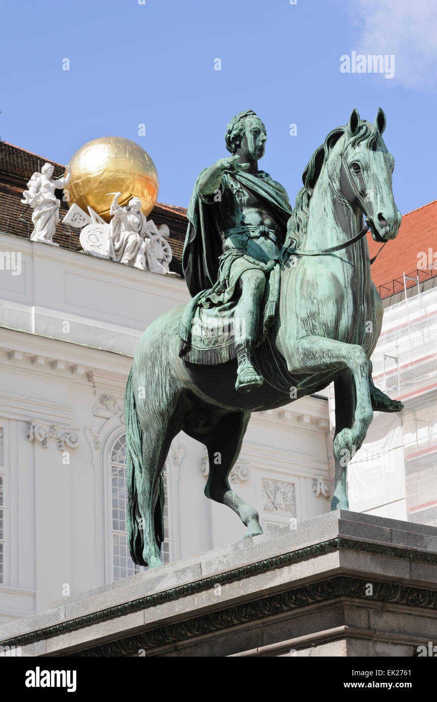 The statue of Emperor Joseph II on horseback with a golden globe on the roof of the Austrian National Library, Vienna, Austria. Stock Photo