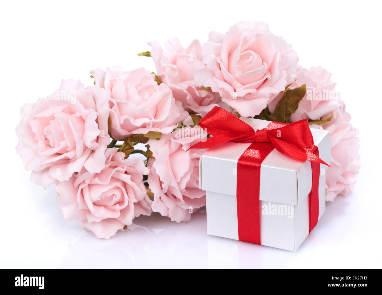 pink flowers and gift box with red ribbon and bow on a white ba Stock ...