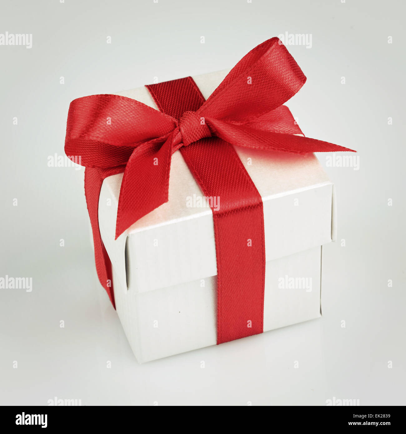 white gift box with red ribbon Stock Photo - Alamy