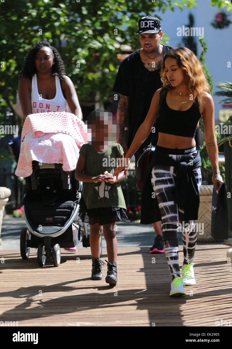 Chris Brown seen with girlfriend Karrueche Tran and friends at The Grove.  They lunched at La Piazza Ristorante then headed for Nordstrom's to shop  before returning to Valet before leaving. Featuring: Chris, image size:923x1390