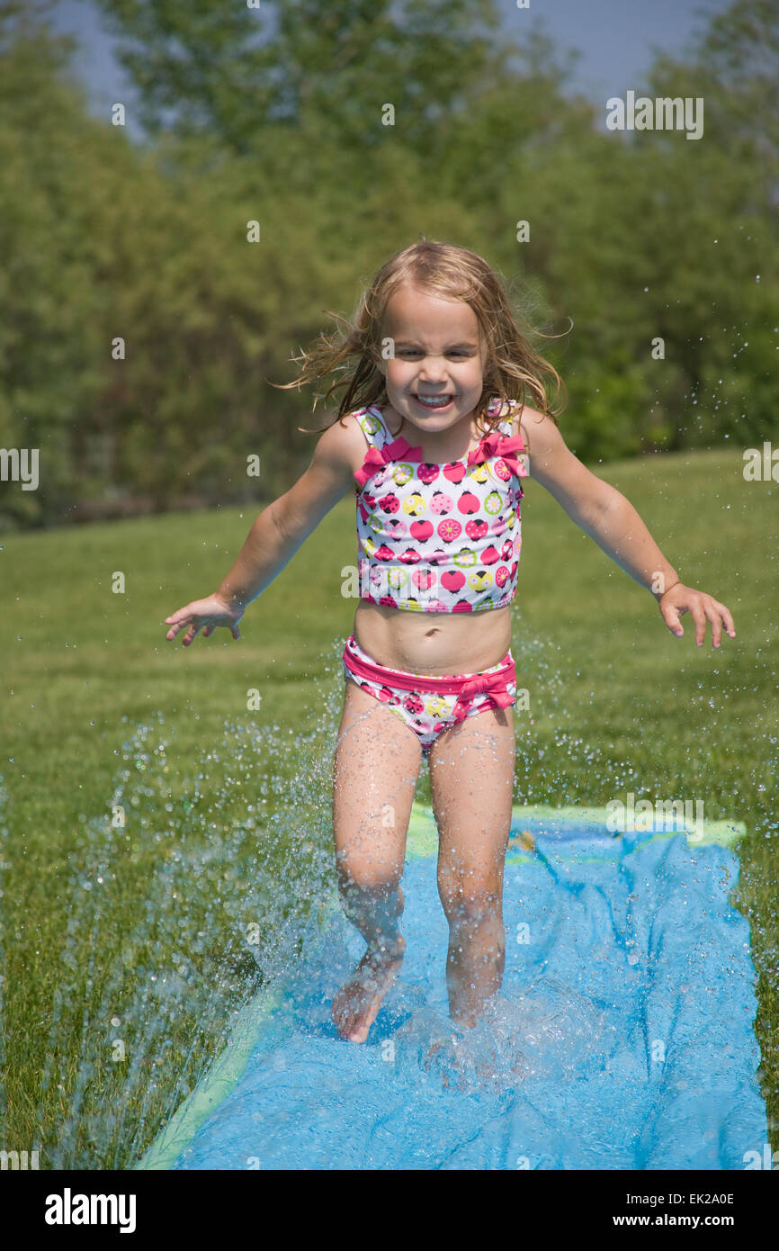 4 year old girls 4 year old girl running and playing in the water on her Slip N Slide in  Gurnee, Illinois, USA Stock Photo - Alamy