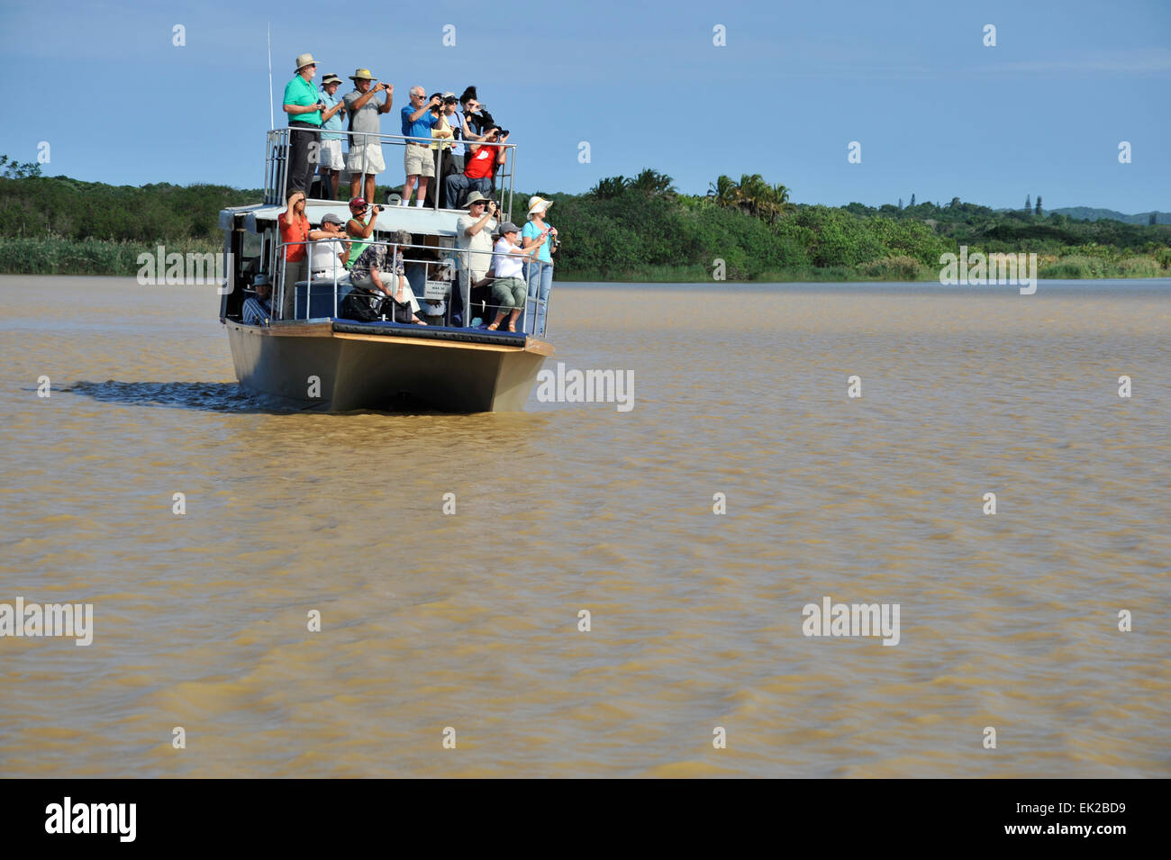 St Lucia, KwaZulu-Natal, South Africa, group of people standing on deck of tourist boat, viewing wildlife, iSimangoliso World Heritage park, landscape Stock Photo
