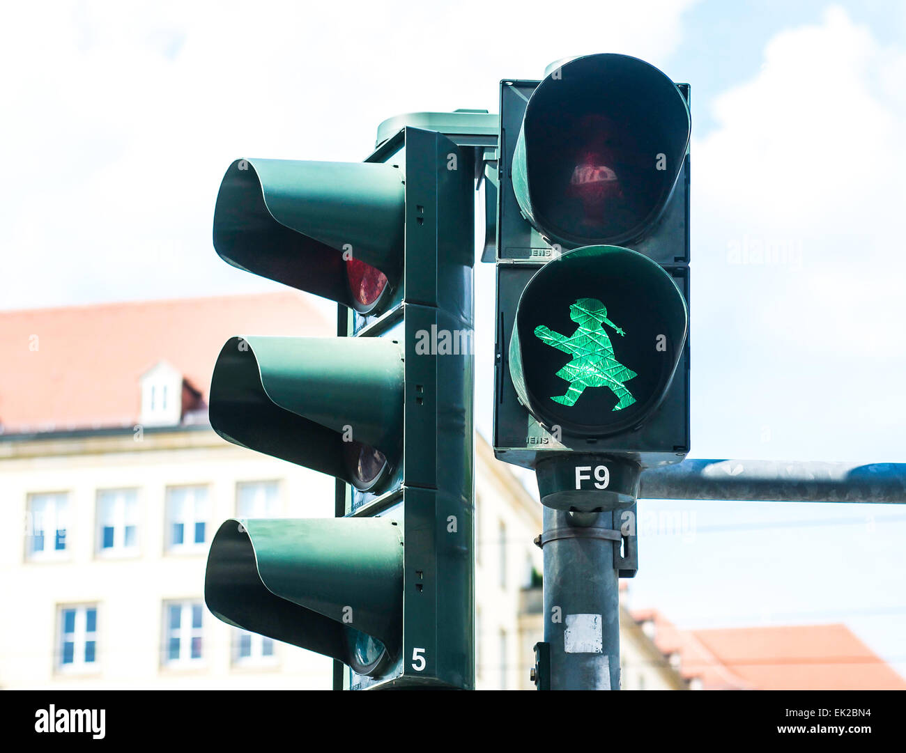 The cartoon-like figure known as Ampelfrau is seen in Dresden, Germany on the red and green pedestrian crossing lights. Stock Photo