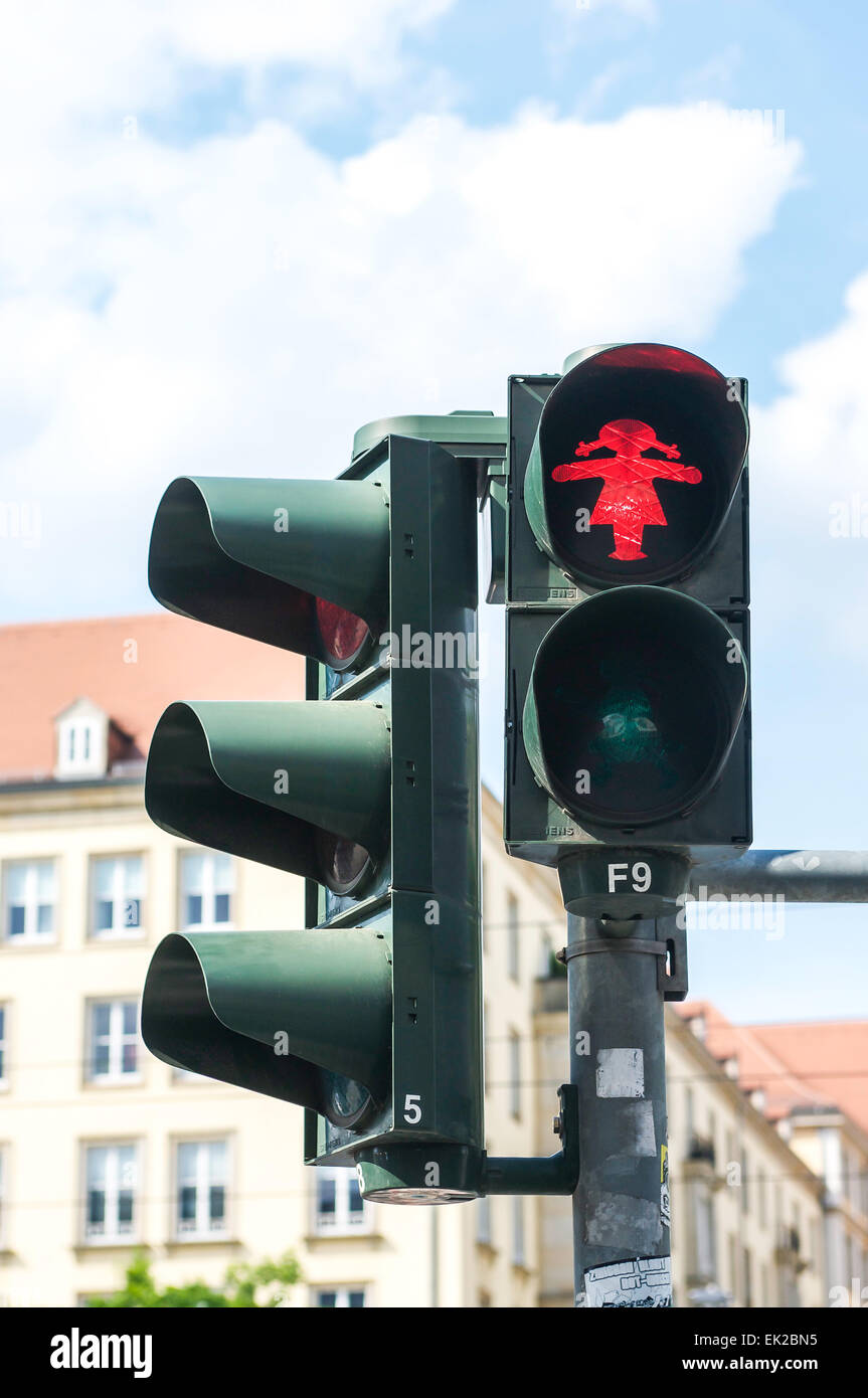 The cartoon-like figure known as Ampelfrau is seen in Dresden, Germany on the red and green pedestrian crossing lights. Stock Photo