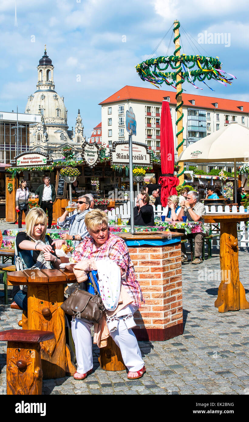 Local citizens and tourists alike enjoy sausages & beer at the Altmarkt outdoor cafes in Dresden, Germany. Stock Photo