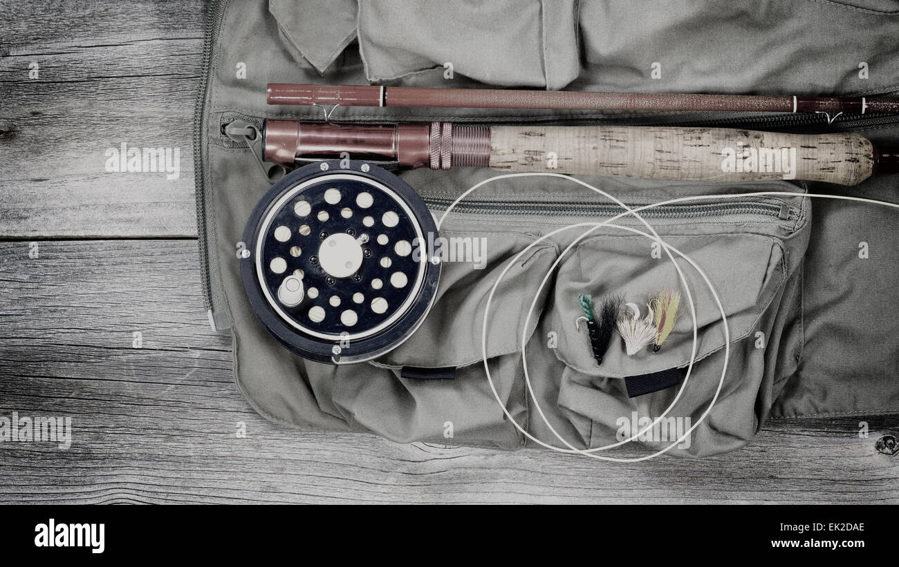 https://c8.alamy.com/comp/EK2DAE/vintage-concept-of-an-antique-fly-fishing-reel-and-rod-with-vest-and-EK2DAE.jpg