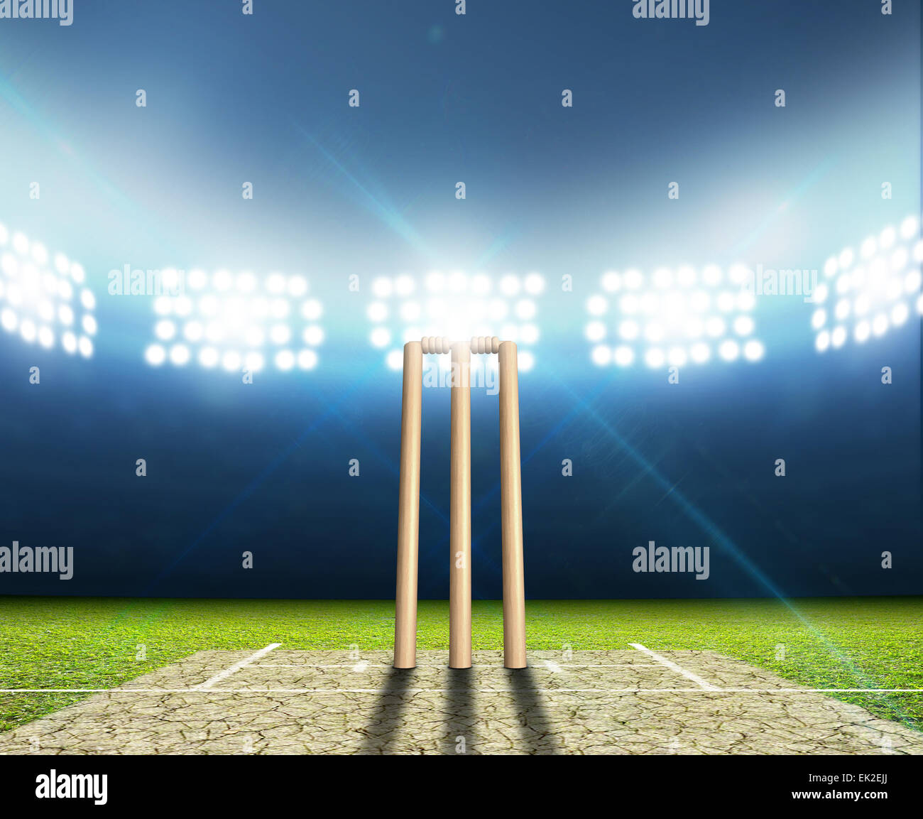 A cricket stadium with cricket pitch and set up wickets at night under  illuminated floodlights Stock Photo - Alamy