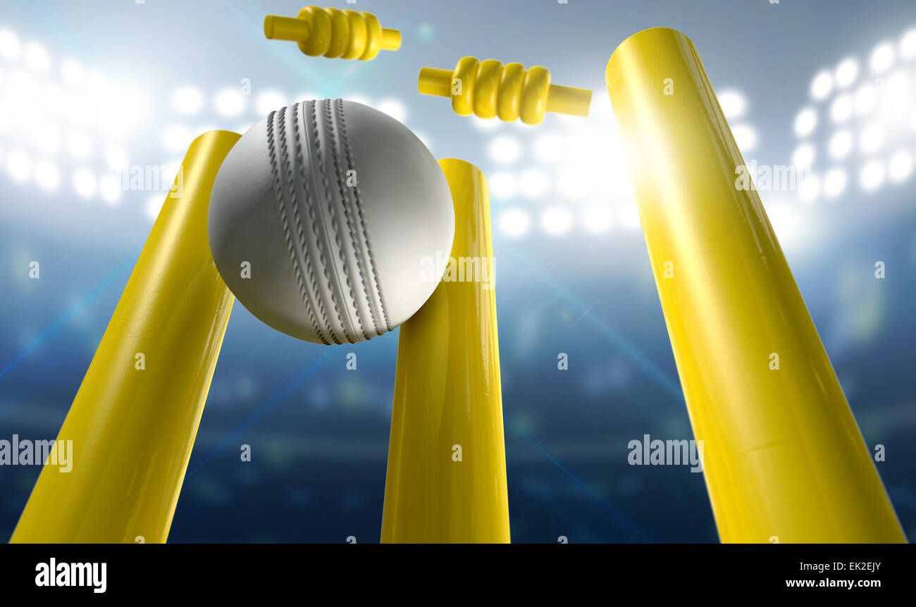 A white leather cricket ball hitting yellow wooden cricket wickets on a