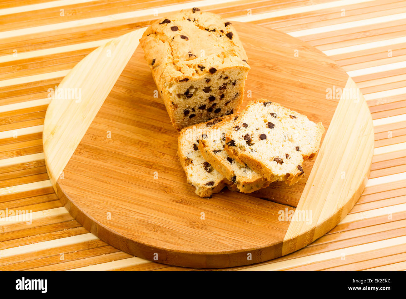 chocolate fruitcake on chopping board Stock Photo