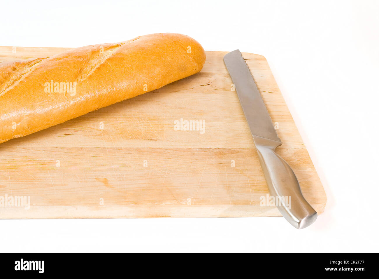 Loaf of fresh baked bread with a knife on a cutting board Stock Photo