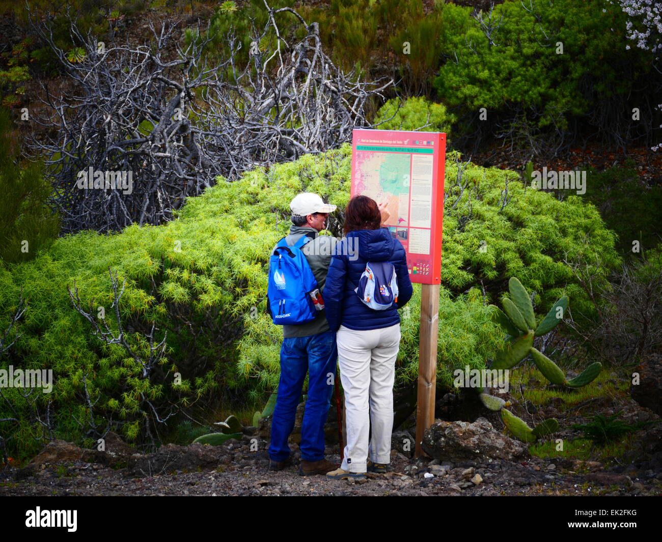 Tourists looking at Trekking information board in North Tenerife island Canary islands Spain Stock Photo