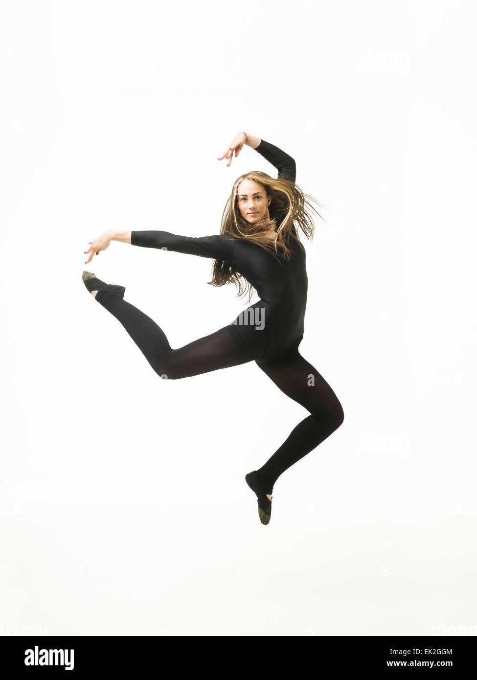 young modern ballet dancer jumping on white background Stock Photo