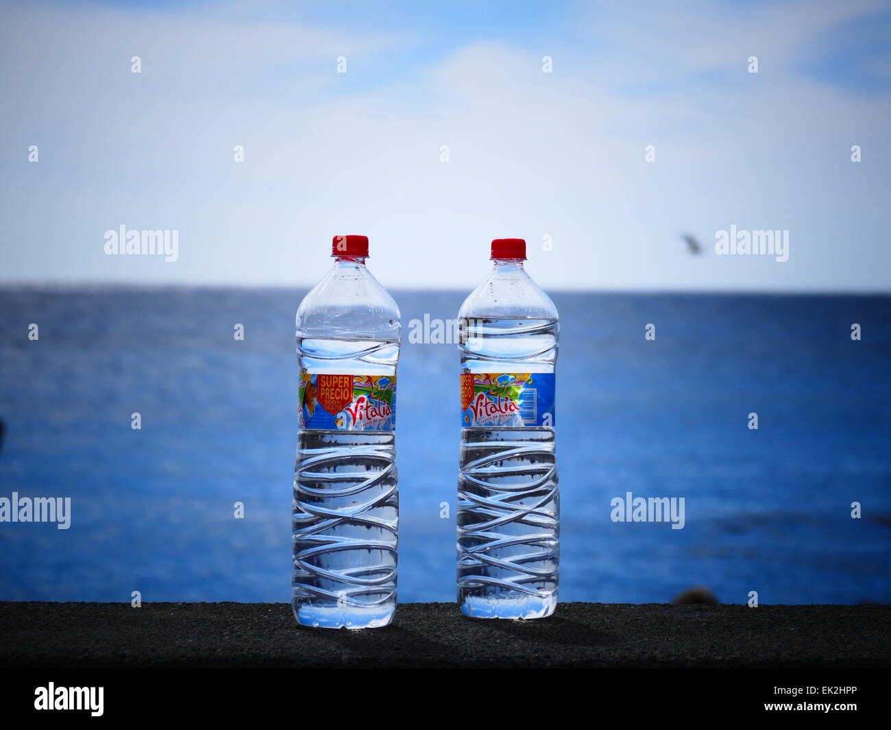 Water bottles against beach La Calera Valle Gran Rey Valley terrace field La Gomera island Canary islands Spain Stock Photo