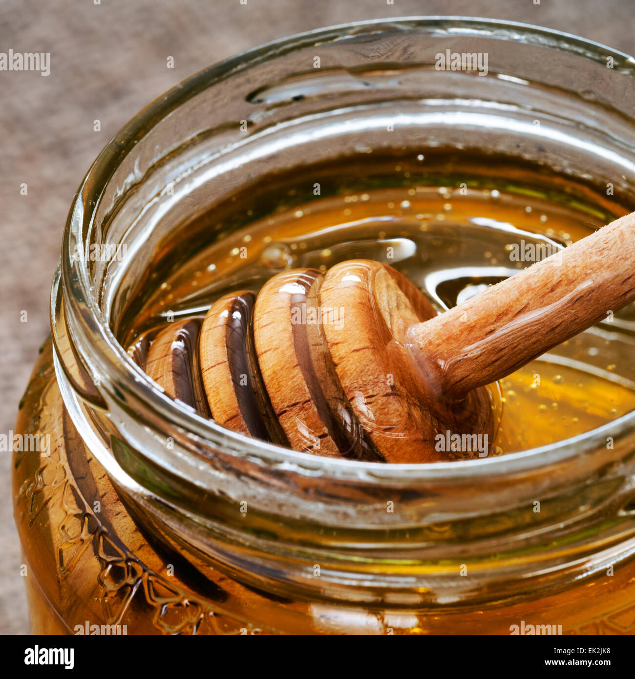 Honey in jar with dipper Stock Photo Alamy