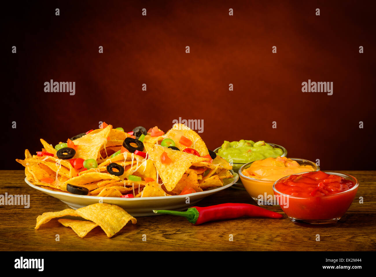 tortilla chips still life with salsa, cheese and guacamole dip Stock