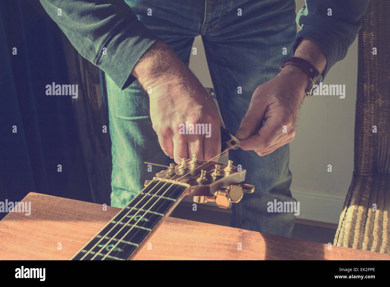 Changing strings on guitar Stock Photo Alamy