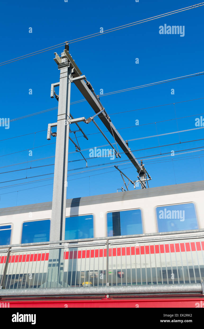 train passing by a railway catenary Stock Photo