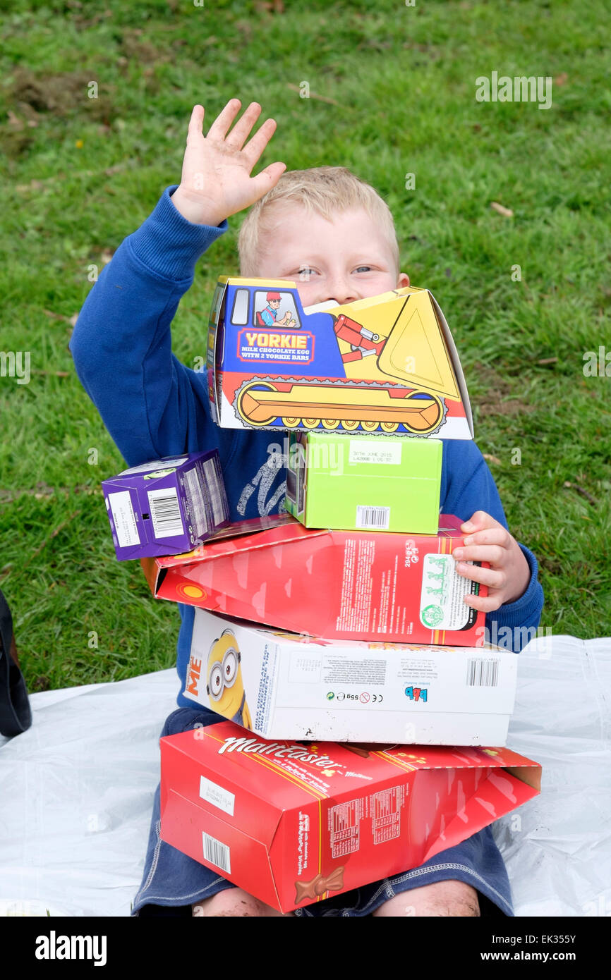 Preston, Lancashire, UK. 6th April, 2015. Six-year old Oliver Jeffries from Preston prepares to take part in the tradition of Egg rolling in Avenham Park, Preston. The tradition has been around for hundreds of years and people turned out in their thousands on Easter Monday to roll chocolate and hard boiled eggs down the hills of the City-Centre park.  The tradition of Easter egg rolling has also been adopted by the United States and there is now an annual Easter Egg rolling event held for children on the White House Lawn. Credit:  Paul Melling/Alamy Live News Stock Photo