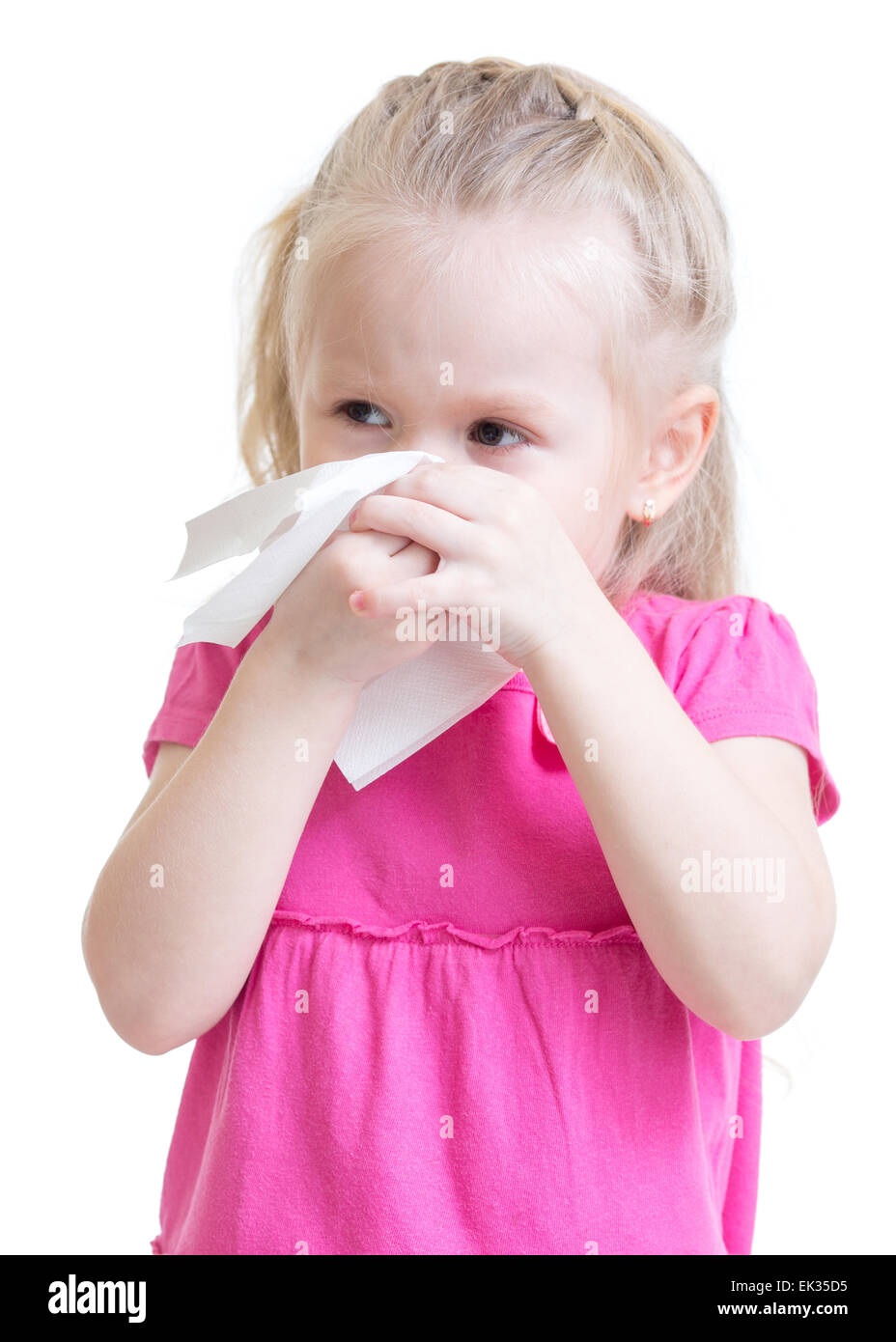 sick kid wiping or cleaning nose with tissue isolated Stock Photo