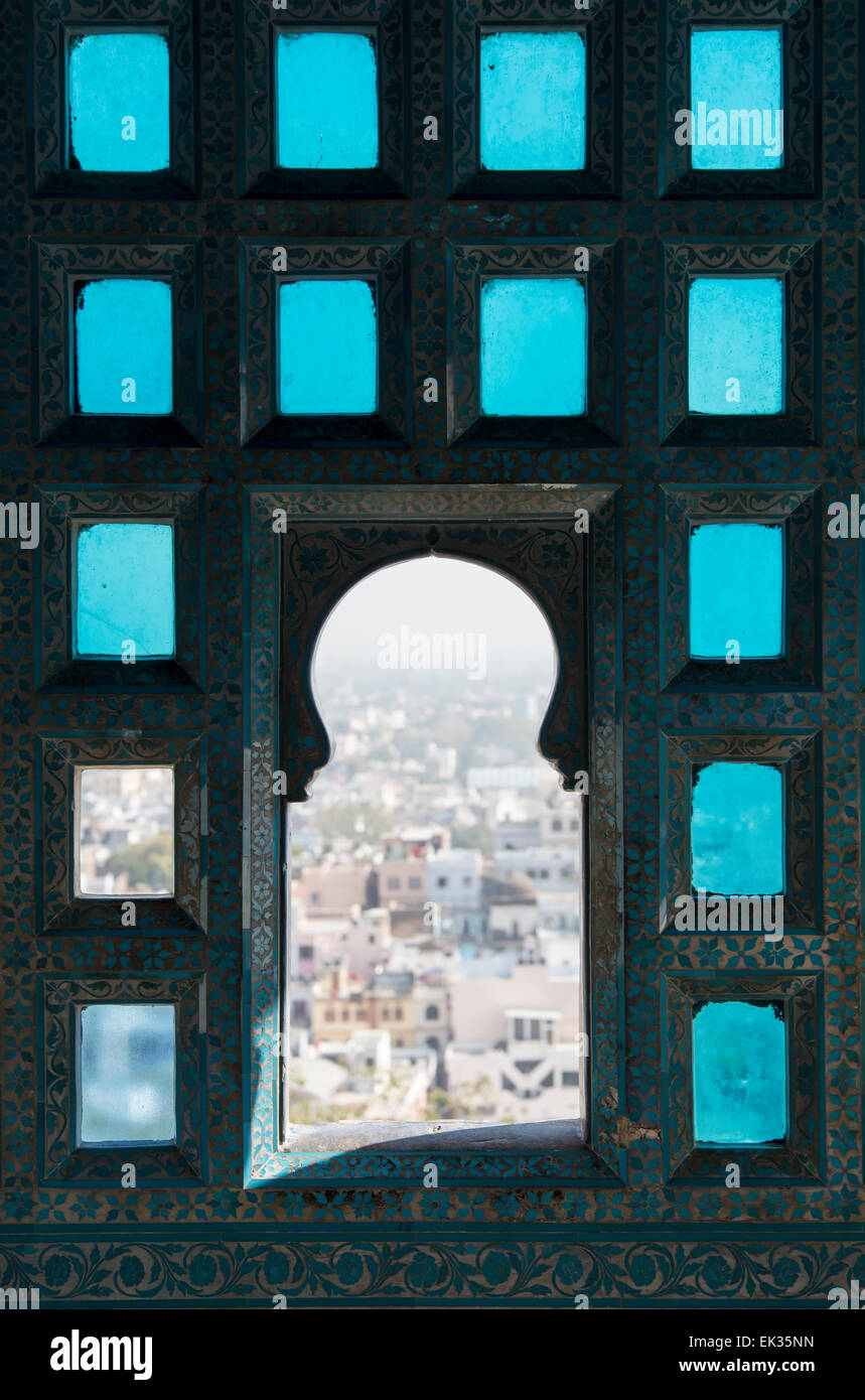 View of Udaipur through Window od Stained Glass in City Palace, Rajasthan, India Stock Photo