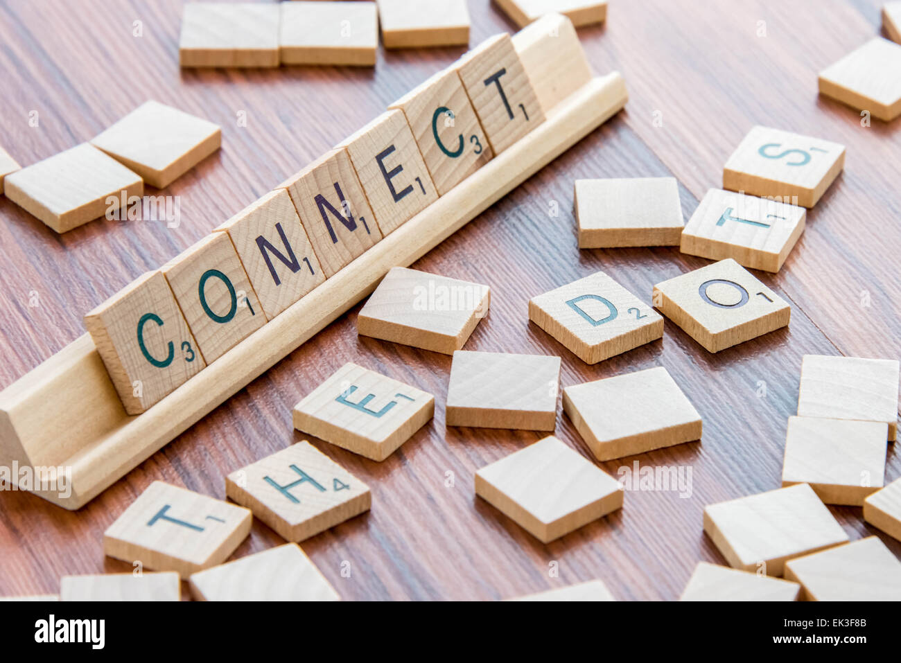 April 4, 2015:  Houston, TX, USA - Scrabble Word Game wood tiles spelling Connect The Dots Stock Photo